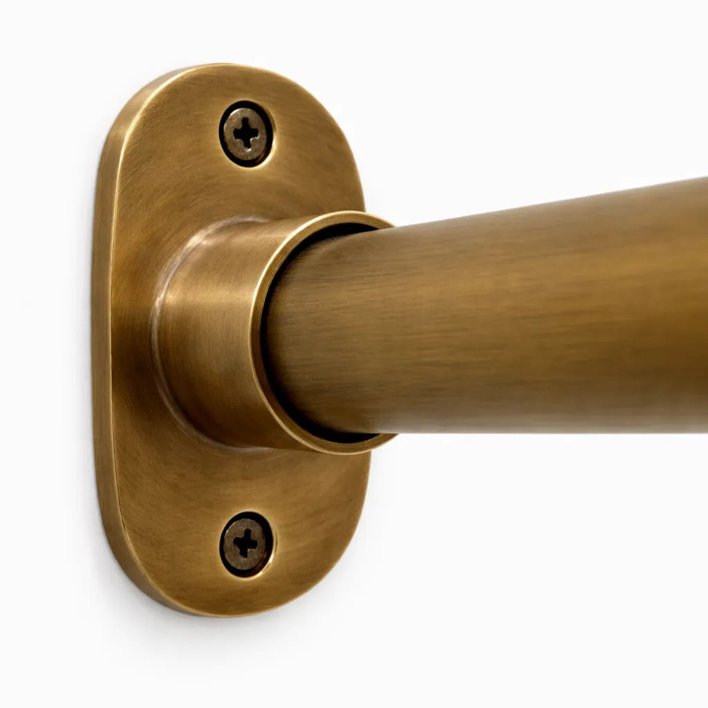 Brass curtain rod bracket on a white background