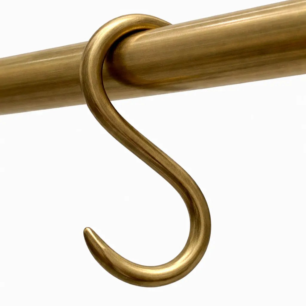 Gold metal hook on a white background