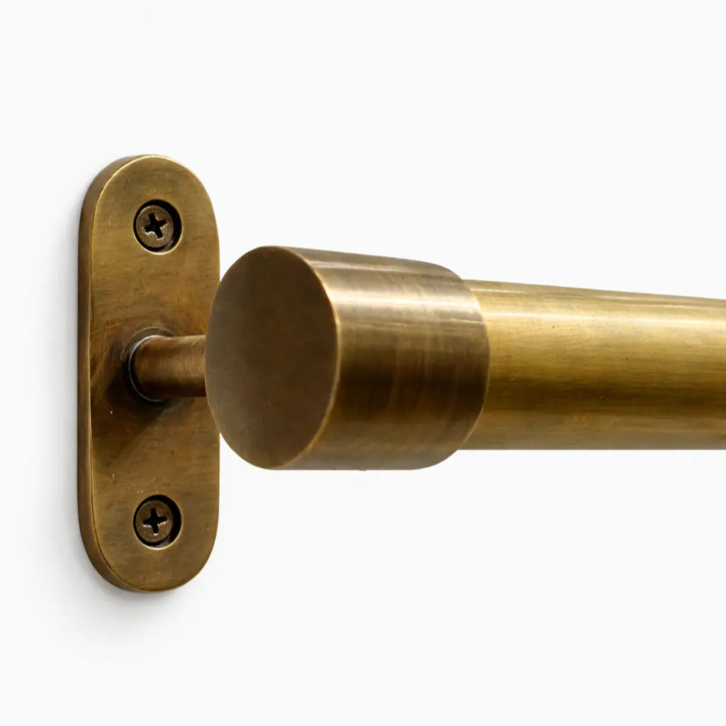 Brass curtain rod bracket on a white background