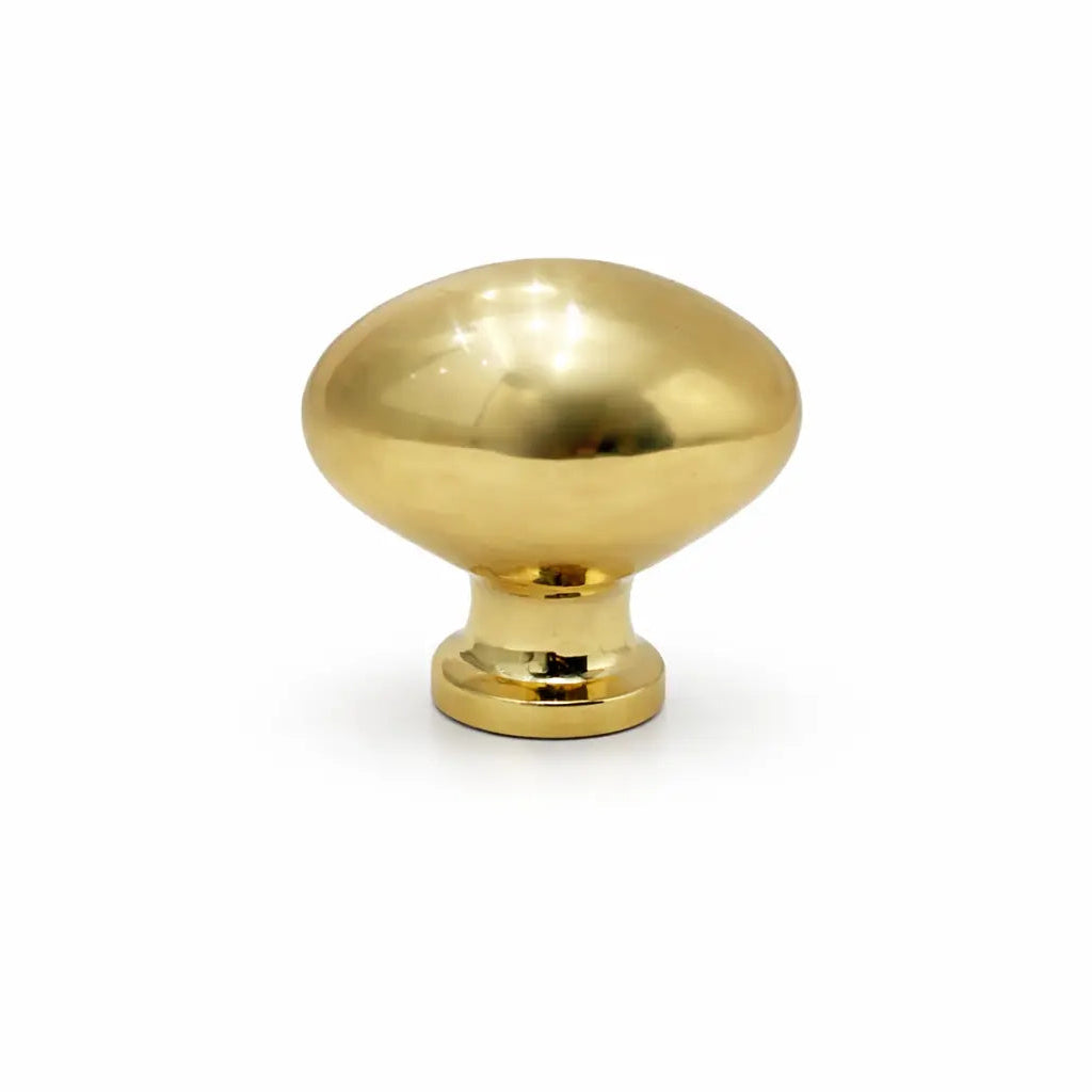 Gold cabinet knob on a white background