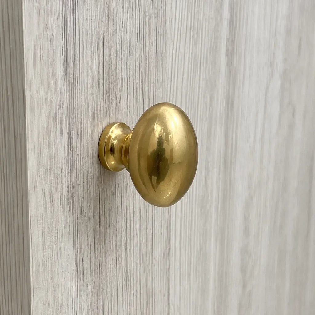 Gold door handle on a wooden door